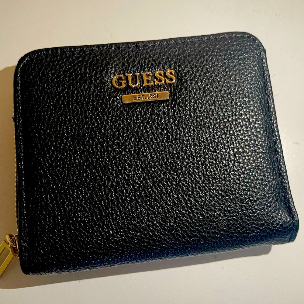 Guess small zip around wallet. Perfect condition. Never used.